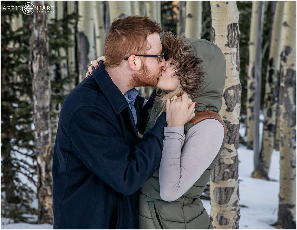 Sweet romantic winter portrait in a forest in Colorado