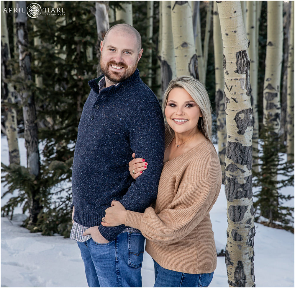Adorable photo of a married couple posing for family pictures in a forest in Colorado
