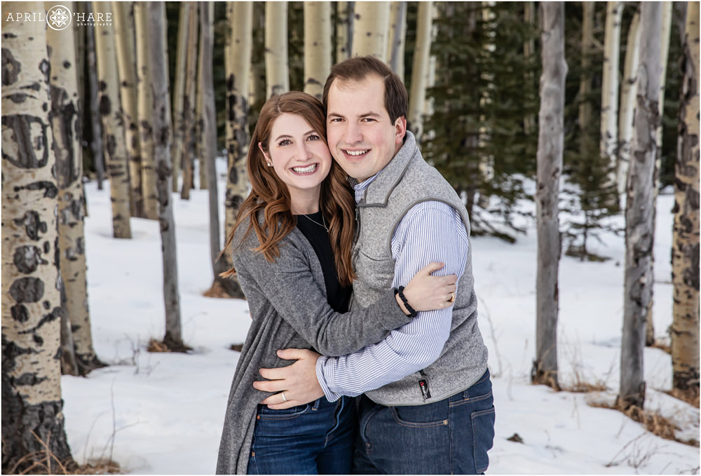 Beautiful portrait of a young couple posing in an aspen tree forest in Colorado