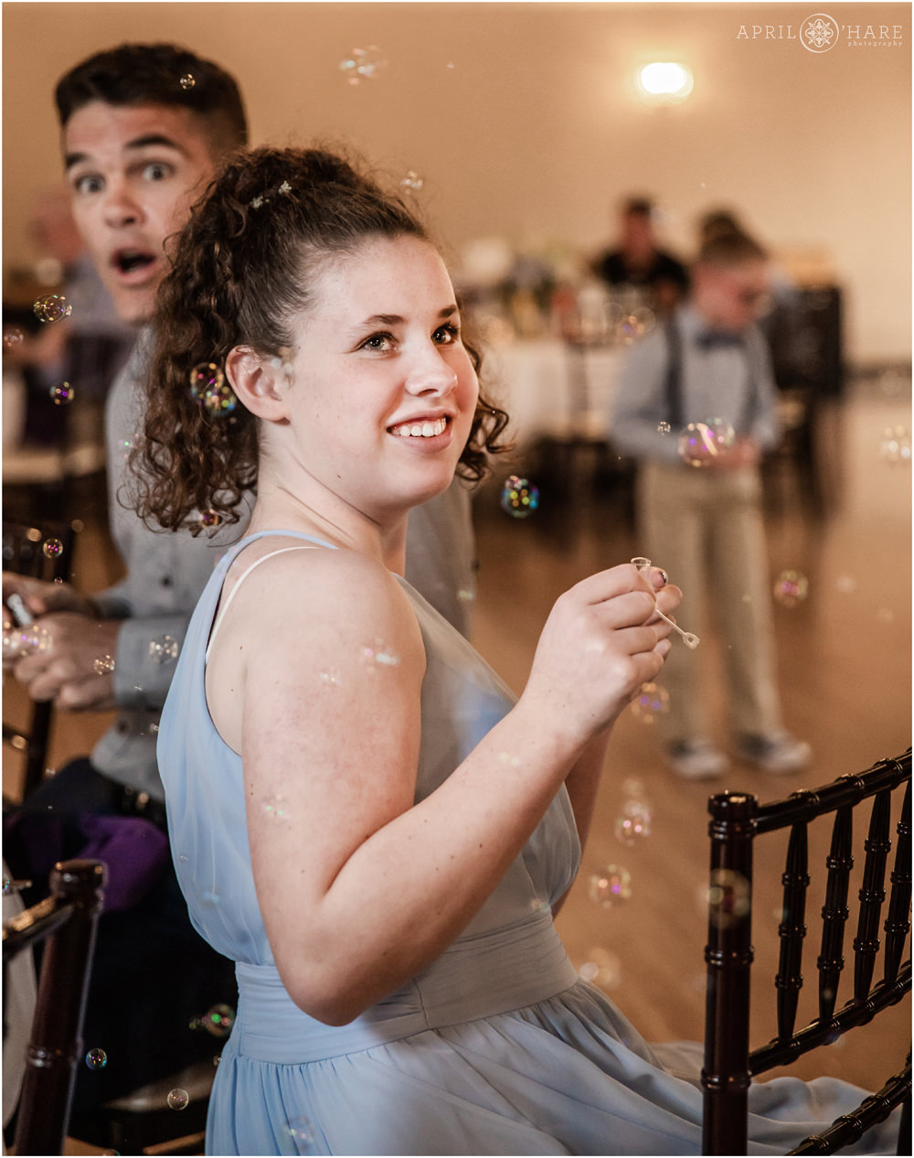 Blowing bubbles during Black Forest Colorado Springs Wedding Reception