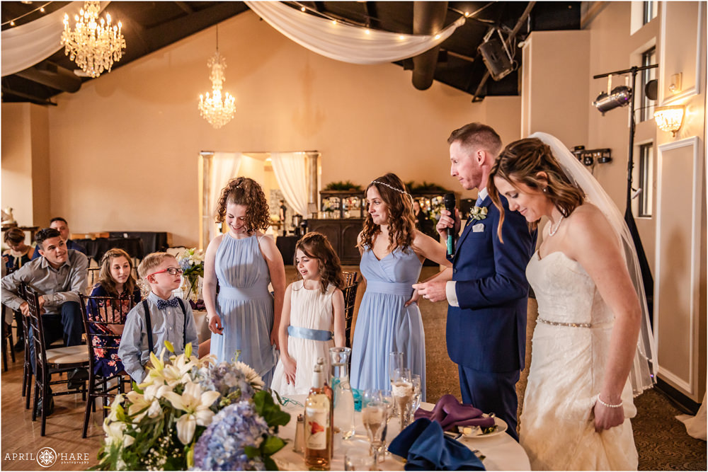 Kids stand with parents during toasts on their wedding day in Colorado Springs