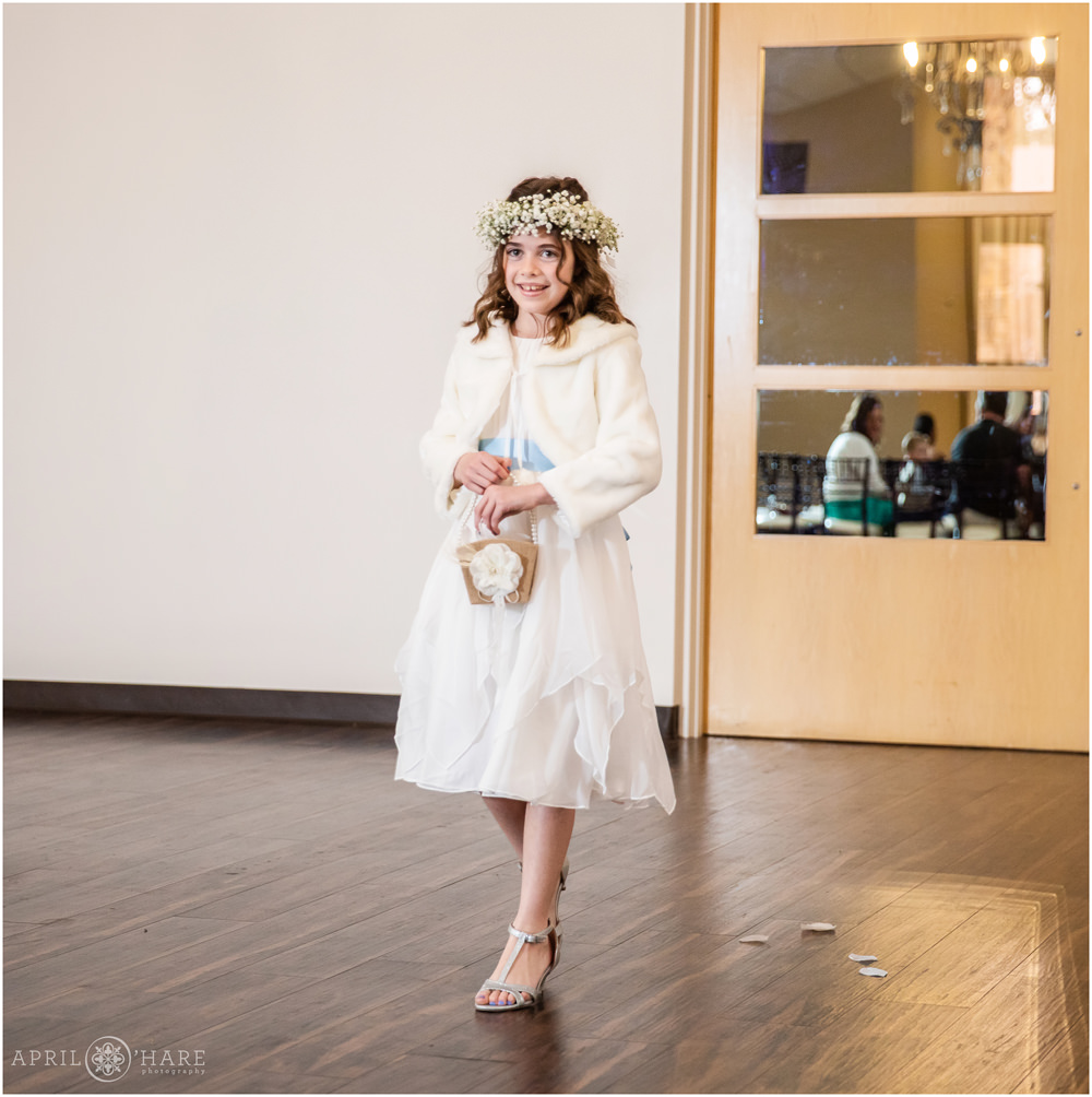 Flower girl walks down aisle at indoor wedding at Black Forest WW