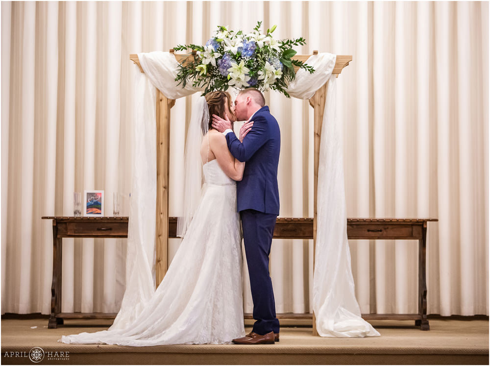 First Kiss at indoor altar at Black Forest Wedgewood Weddings