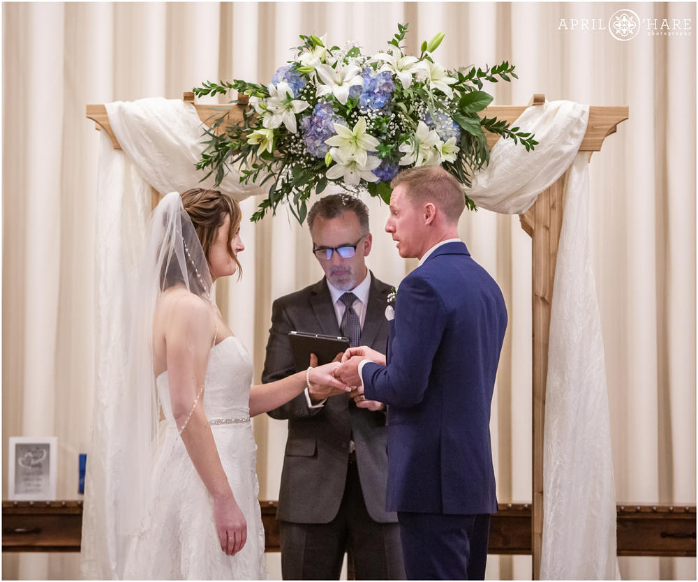 Indoor ceremony at Wedgewood Weddings Black Forest under altar ring exchange