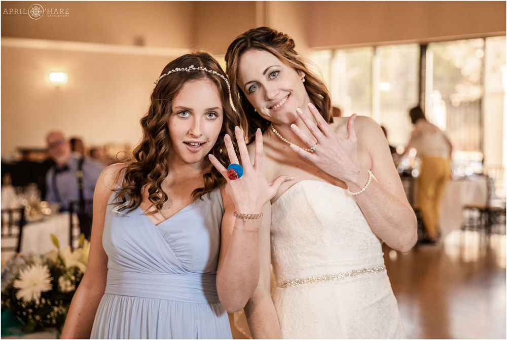 Bride with her daughter showing off their rings