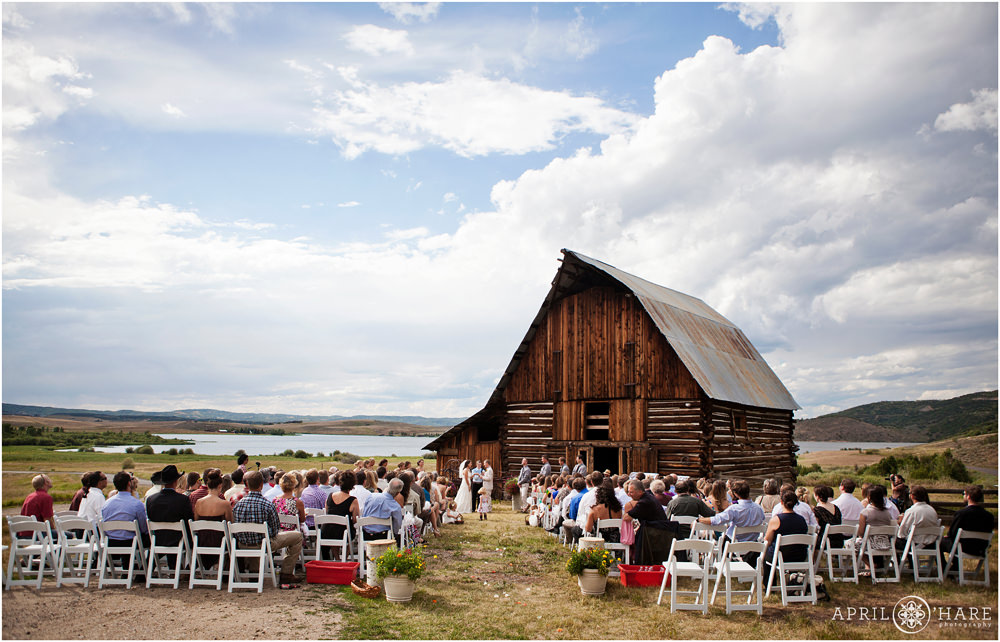 Outdoor wedding ceremony in front of a Steamboat Springs barn wedding venue