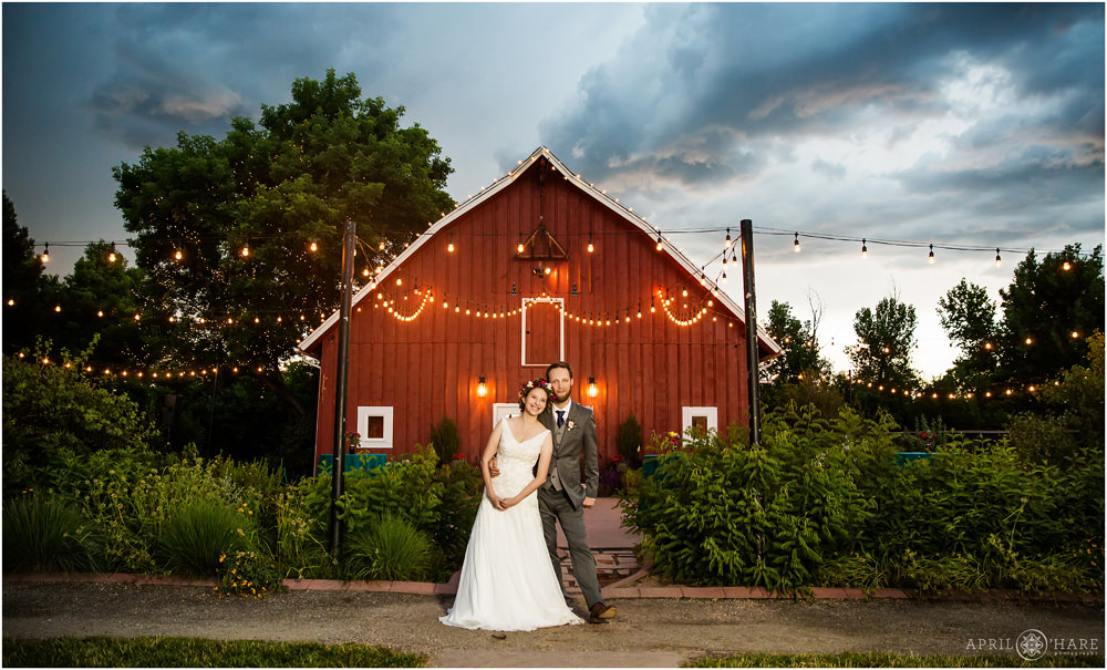 Lovely wedding portrait in front of a red barn in Colorado