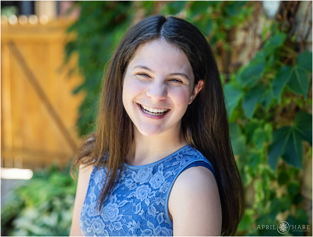 A happy smiling Bat Mitzvah girl posing for a portrait at her Denver home in Colorado