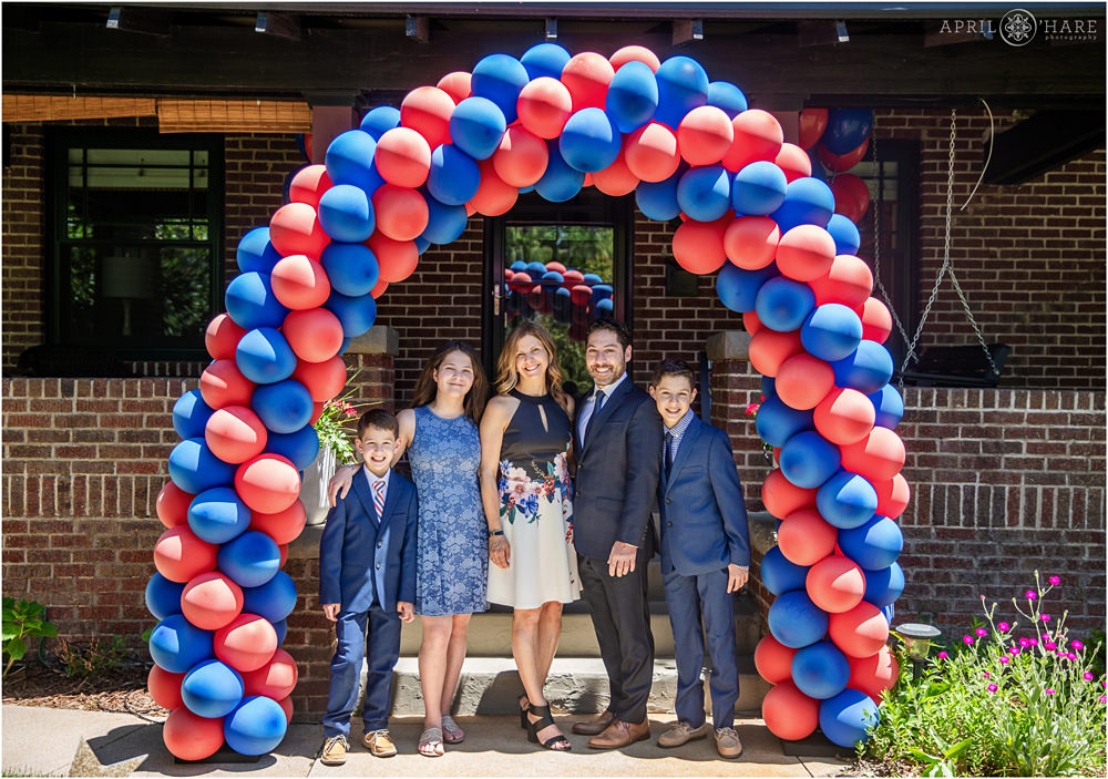 Red and Blue Balloon arch decorates front yard for at home B'nai Mitzvah in Denver
