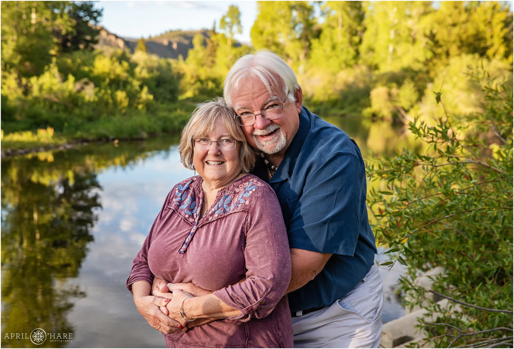 Nice portrait of grandparents at sunset with the Colorado River behind them in Granby CO
