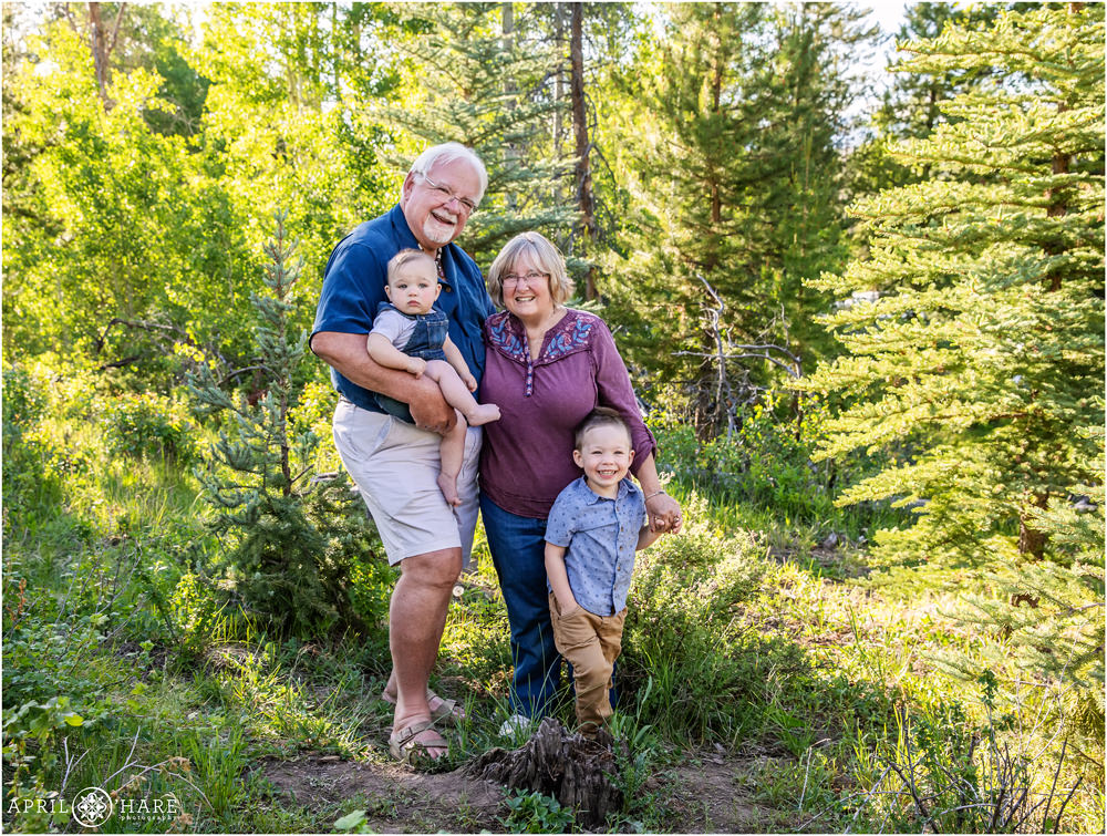 Grandparents get a nice photo with their young grandsons in a Colorado forest in Granby