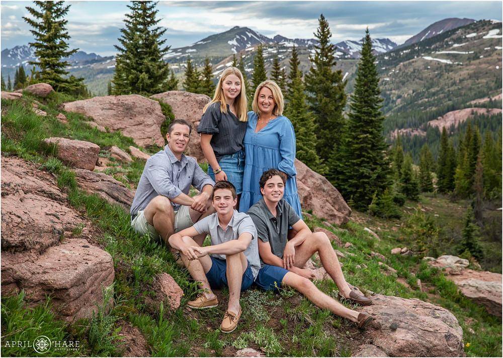 Shrine Pass Family Photos with red rocks, forest, and mountain backdrop near Vail CO