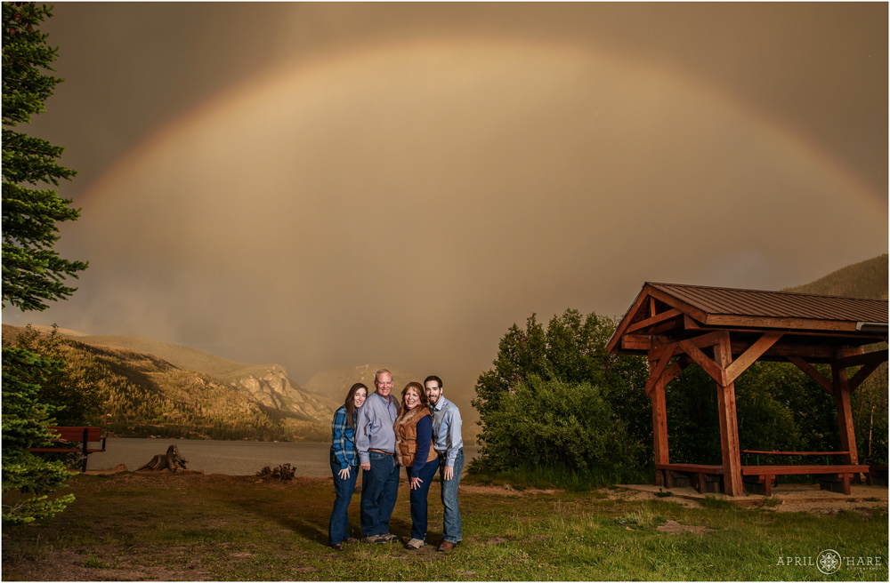 Incredible family photo with a huge rainbow backdrop at Point Park in Grand Lake Colorado