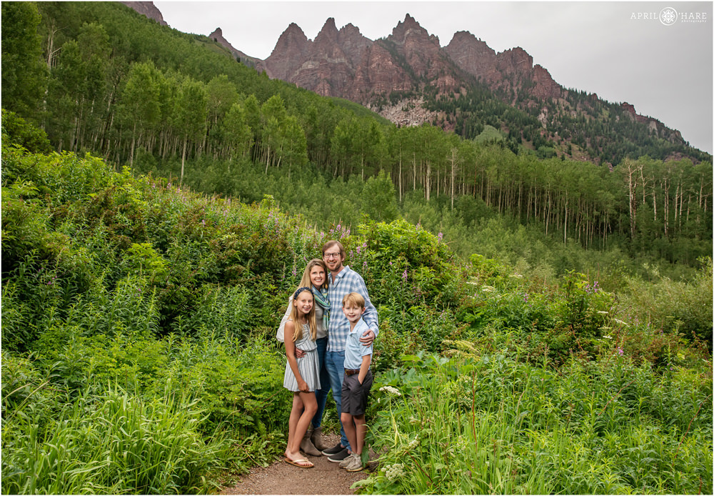 Family photo with four people in dramatic scenery in the Aspen Colorado area