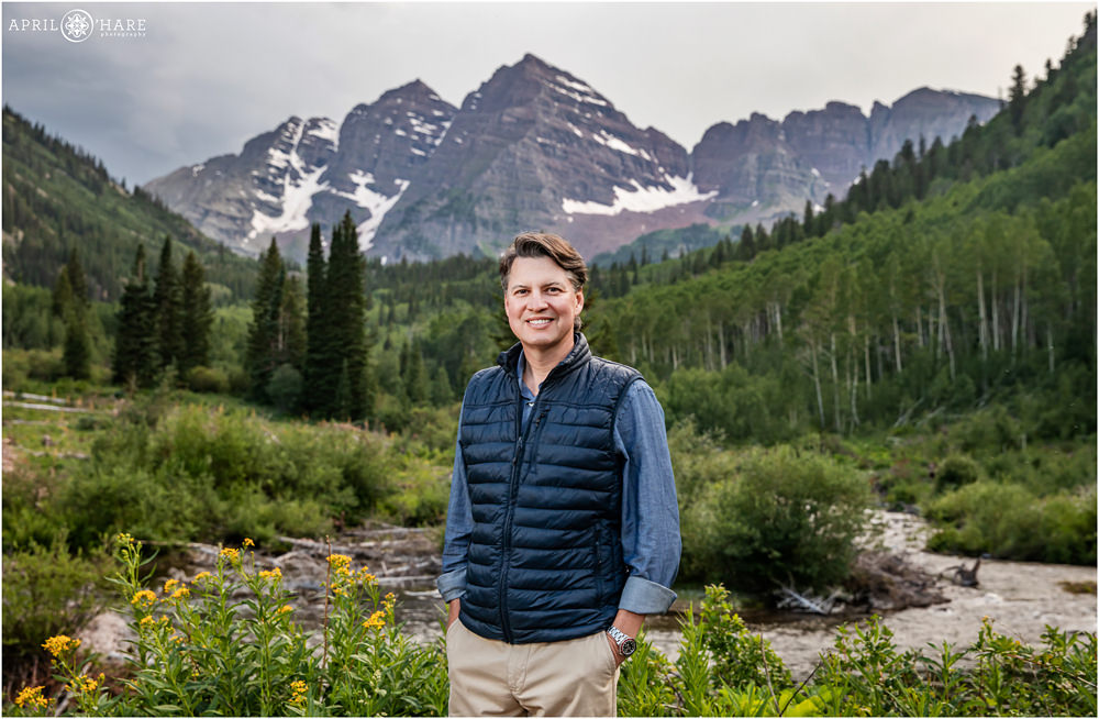 Dad poses for an individual photo in front of the epic Maroon Bells mountain scenery near Snowmass Village, Colorado