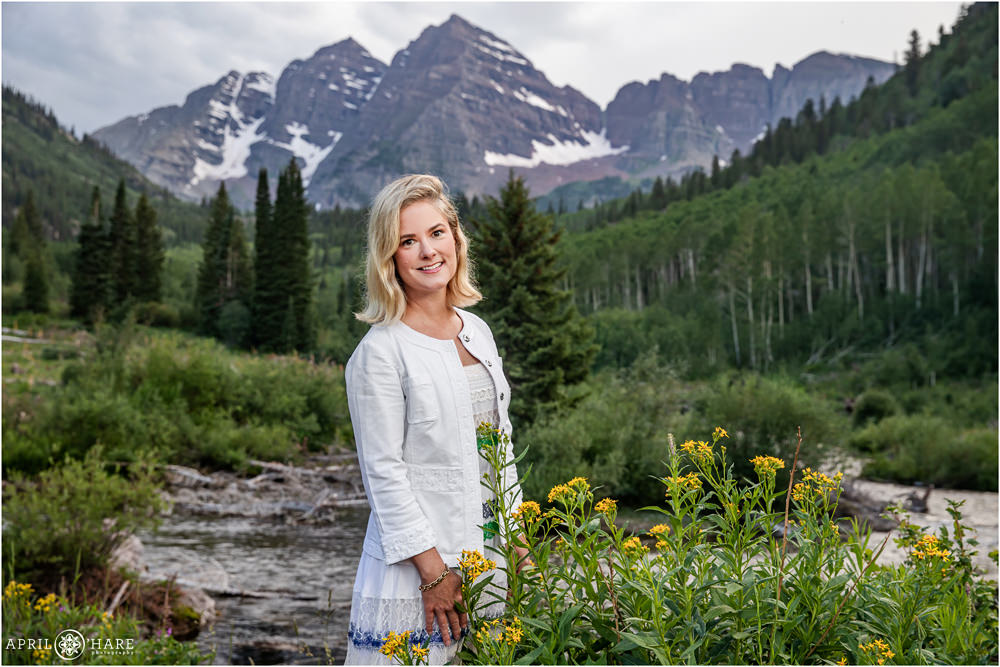 Snowmass Village family photographer poses mom by herself in front of the Maroon Bells backdrop in Colorado