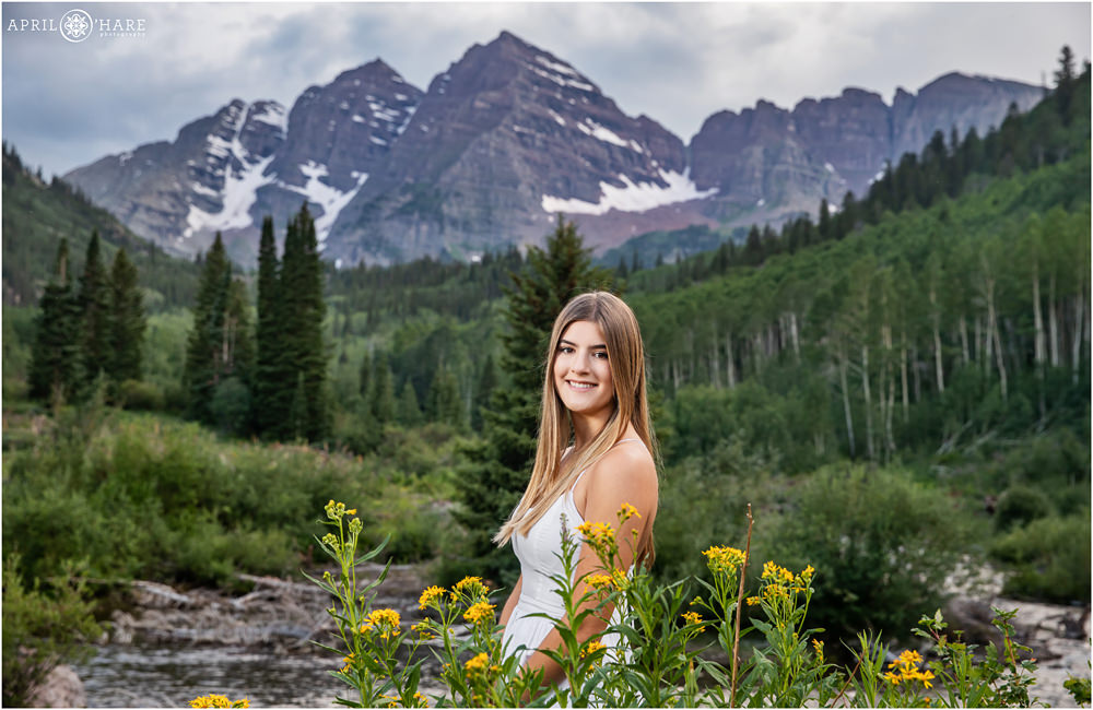 Gorgeous high school senior girl poses in front of the dramatic Maroon Bells backdrop at her Snowmass Village Family Photography session