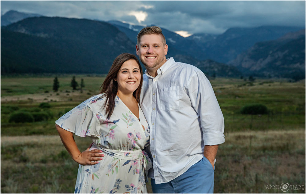 Beautiful couple pose for a portrait together in front of the gorgeous views at Moraine Park in Estes Park Colorado
