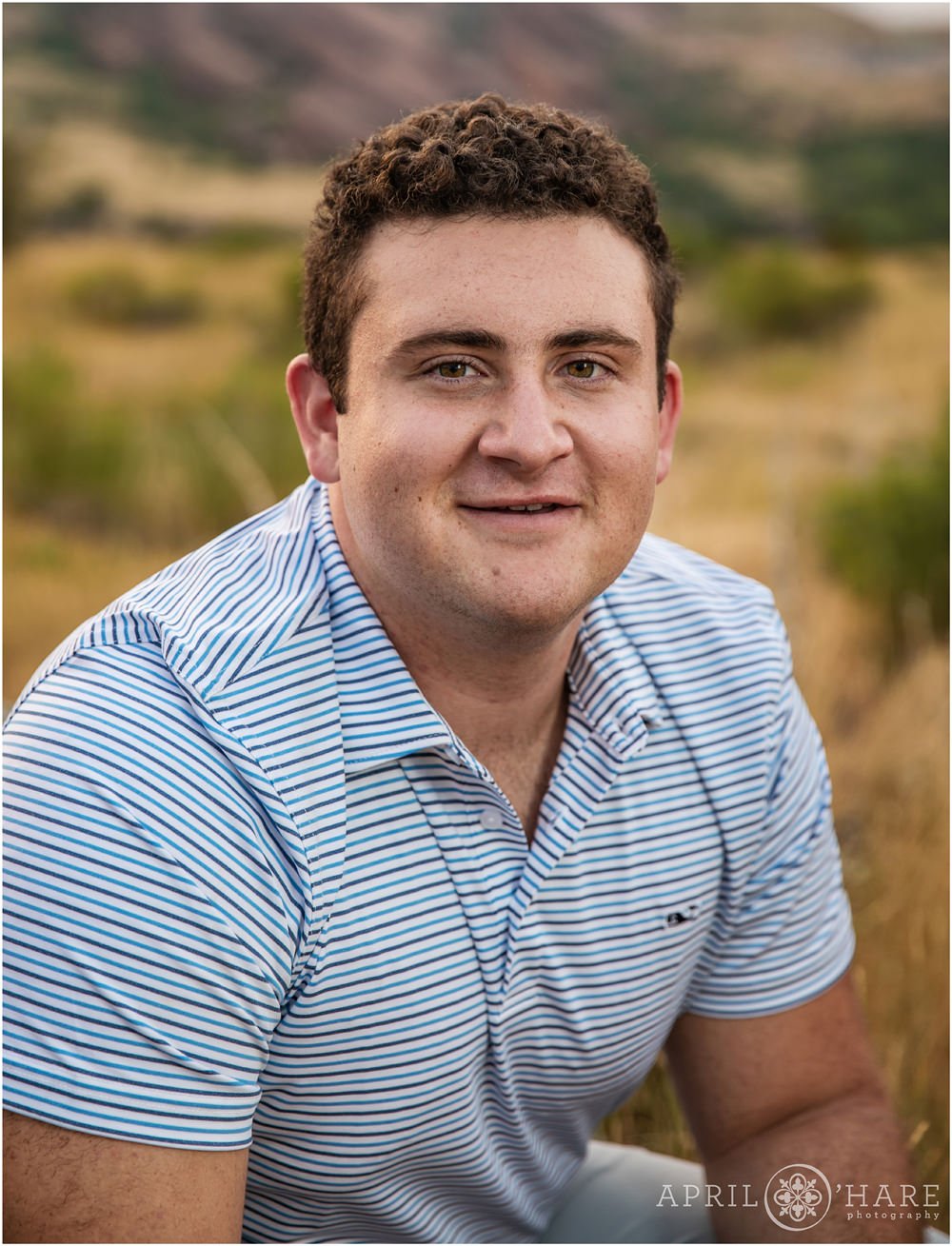 Classis Senior Picture headshot at for a guy with short dark curly hair at East Mount Falcon in Morrison CO
