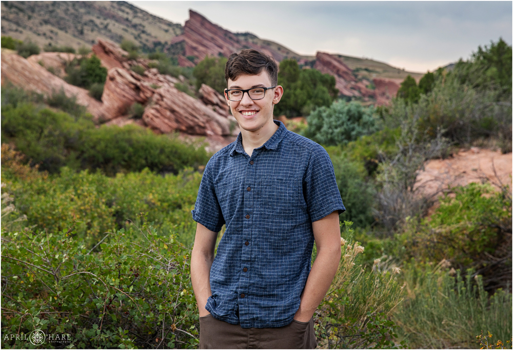 Colorful high school senior portrait with red rock backdrop in Morrison Colorado