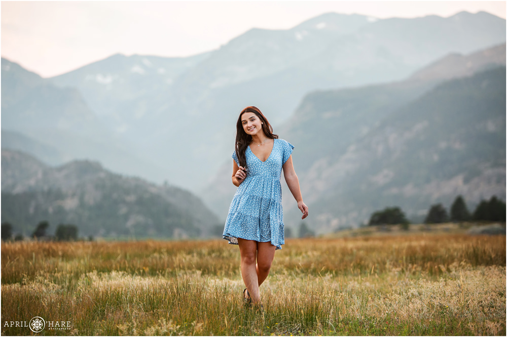 Cute senior girl senior photos with hazy mountain backdrop in Rocky Mountain National Park