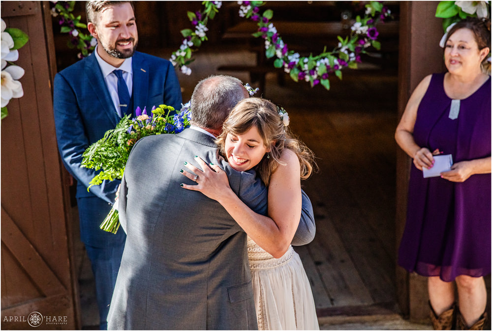 Bride hugs her dad wedding ceremony in Colorado