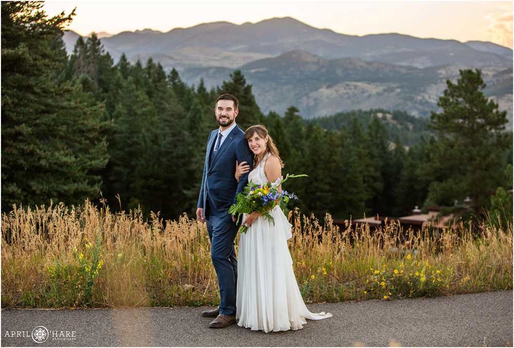 Classic portrait of a bride and groom in front of a pretty mountain view on Lookout Mountain in Colorado