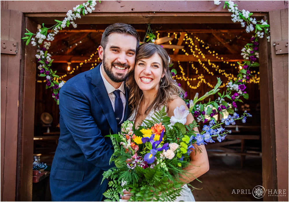 Cute colorful wedding photo with string light backdrop at a Rustic Colorado wedding