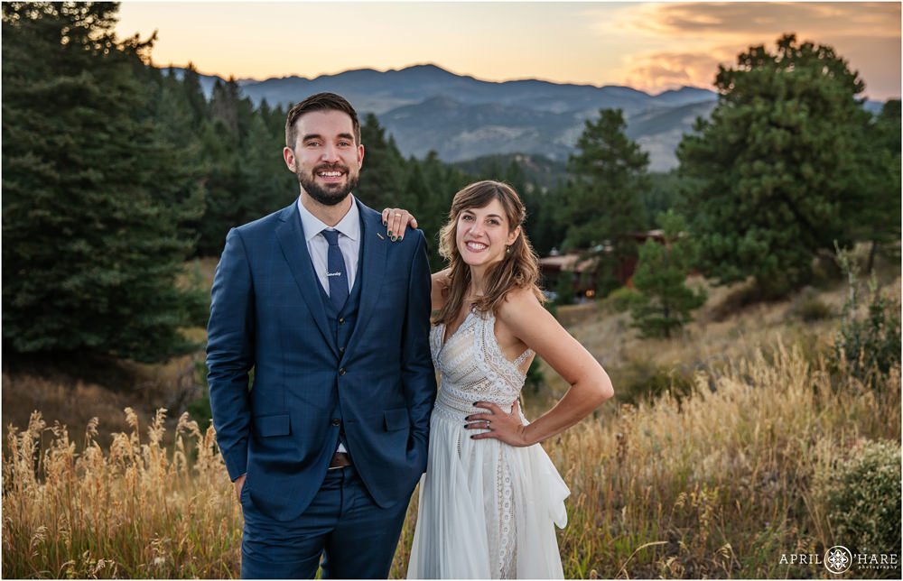 Beautiful casual bride and groom portrait in front of a sunset mountain view on Lookout Mountain in Colorado