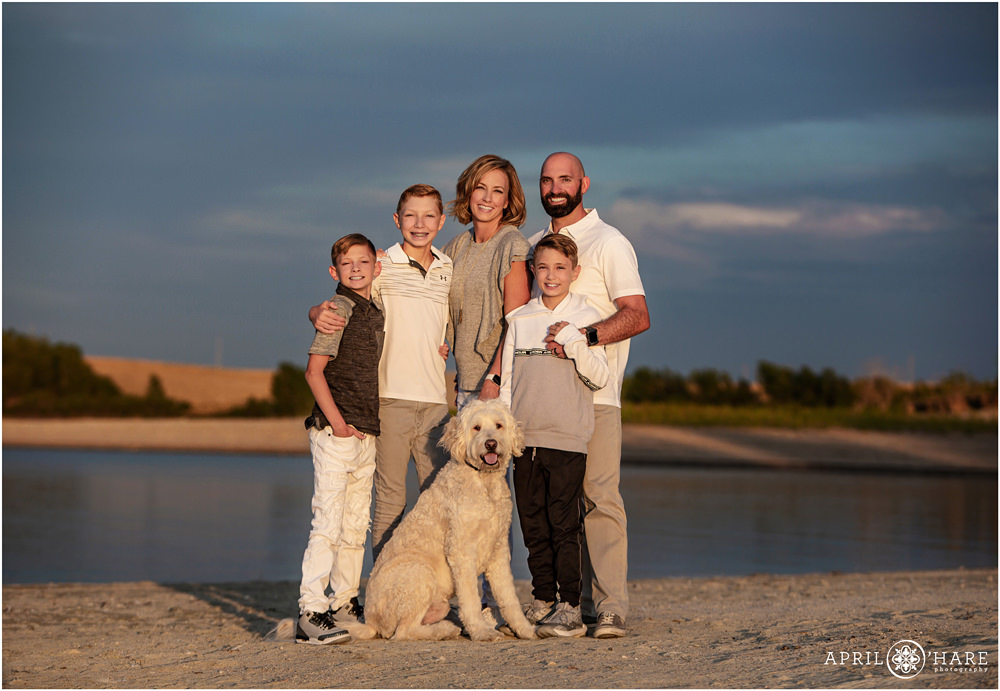 Bright sunset light on a family at their beach photo session at the Aurora Reservoir