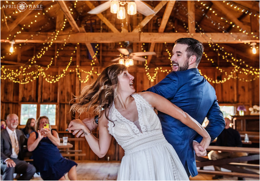 Fun action photo of bride and groom dancing on their wedding day in Colorado
