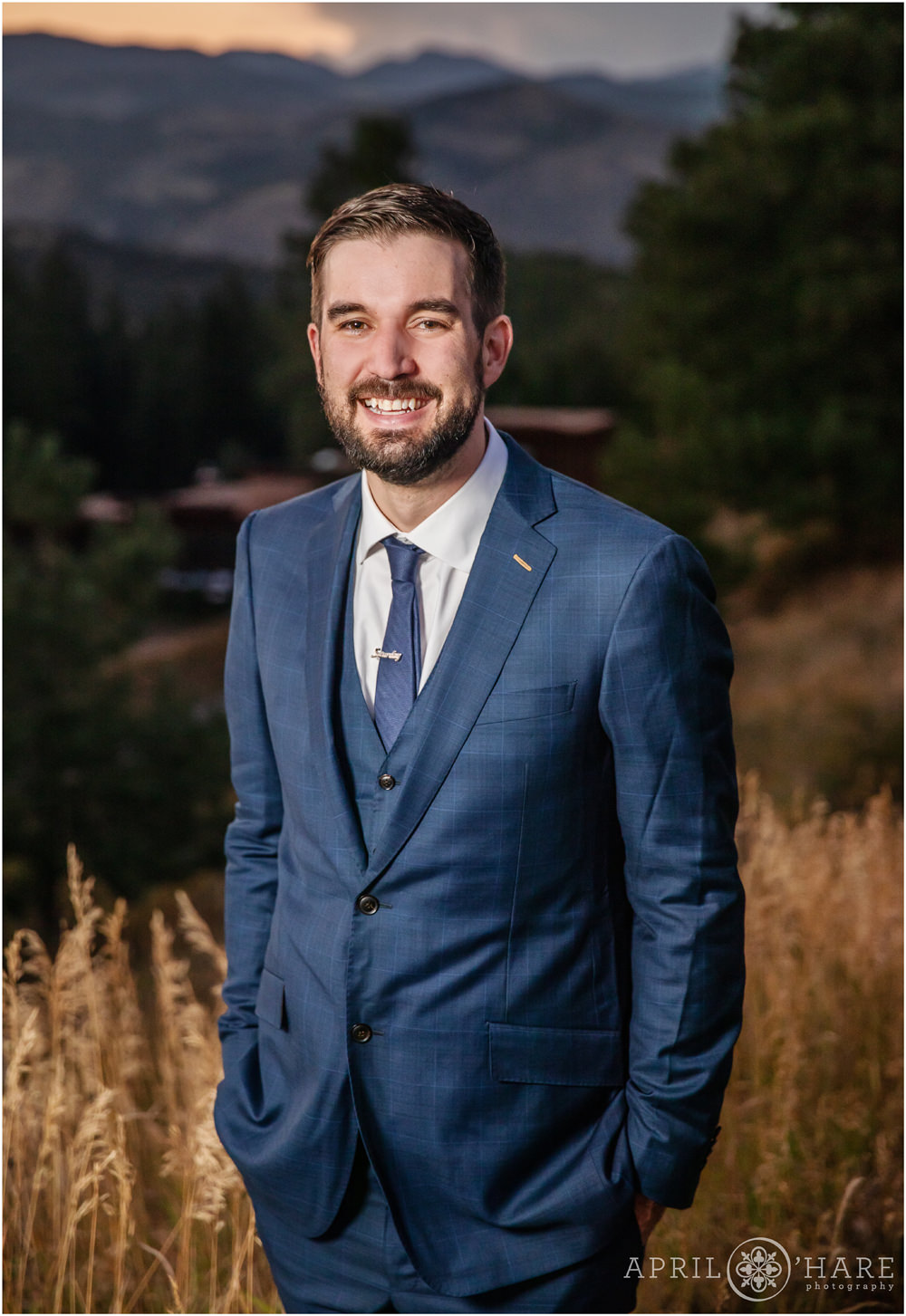 Groom portrait with sunset mountain backdrop and tall grasses on Lookout Mountain in Golden Colorado