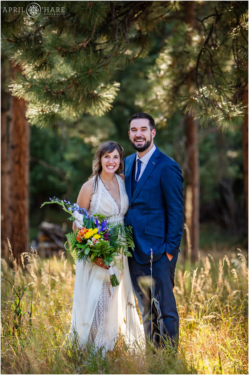 Vertical full length portrait of a bride and groom in the woods on Lookout Mountain in Colorado