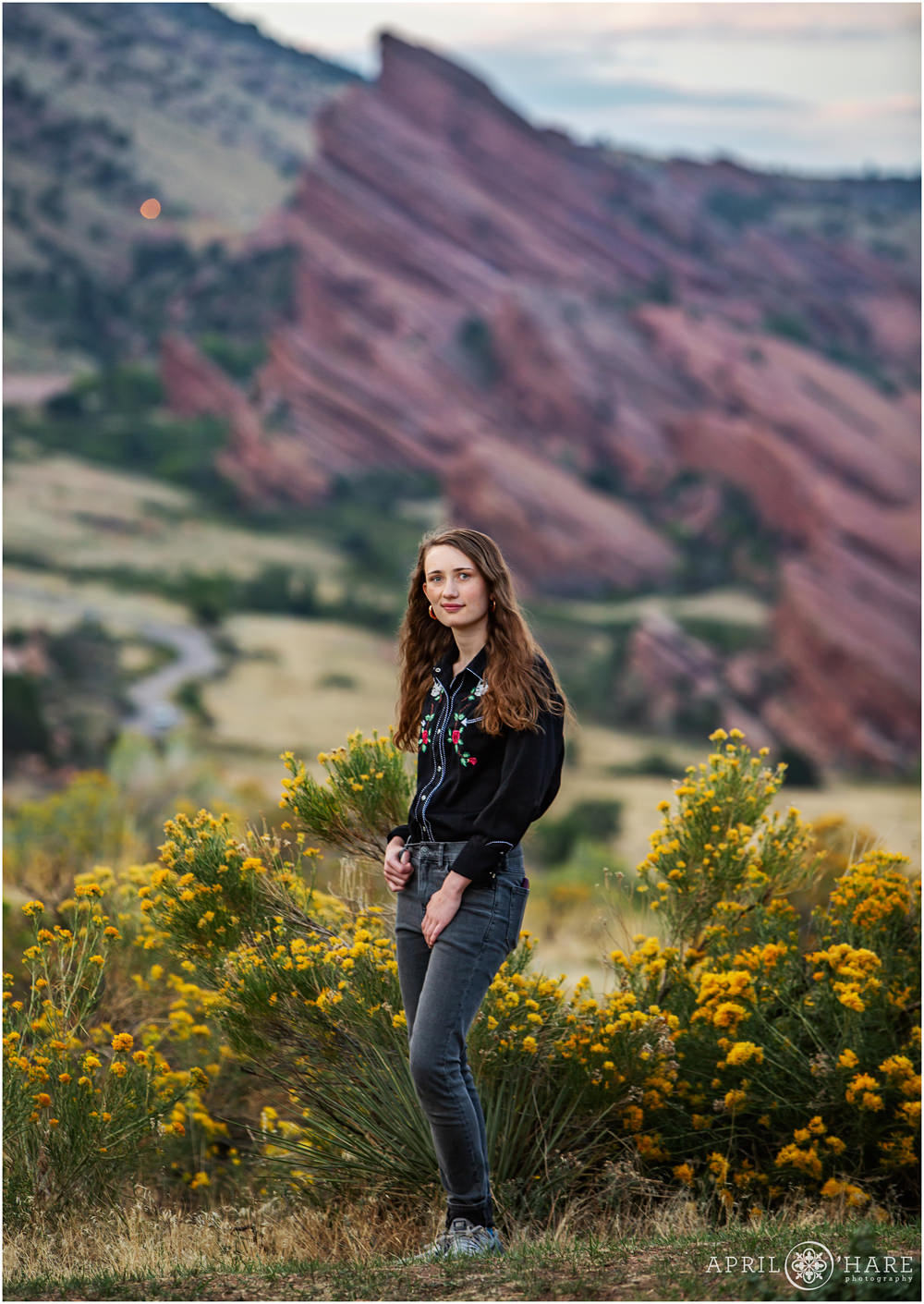 Senior girl portrait at East Mount Falcon Trail with views of Red Rocks in the distance in Colorado