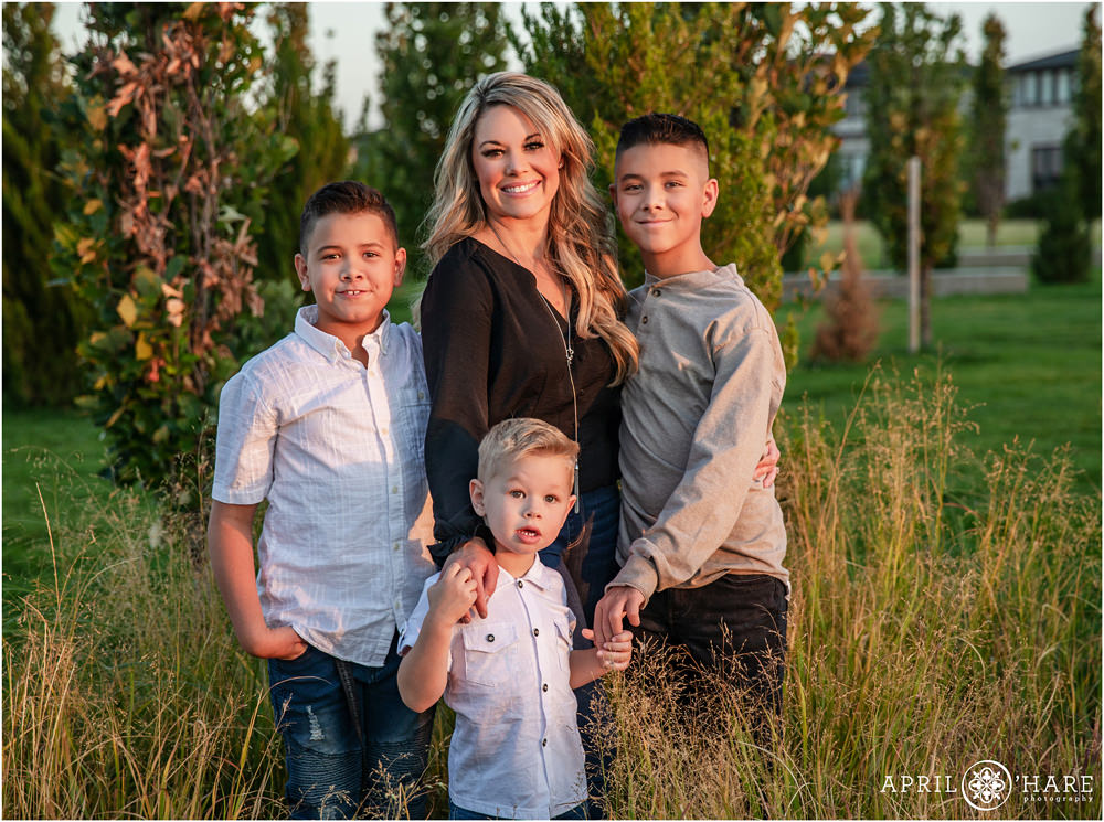 A mom with her 3 sons at Prairie Meadows Park in Northeast Denver on a warm sunset evening