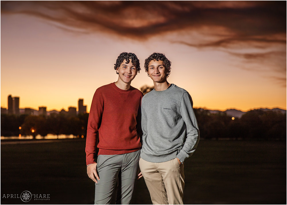 A high school senior boy with his big brother at sunset on a smoky night at City Park in Denver