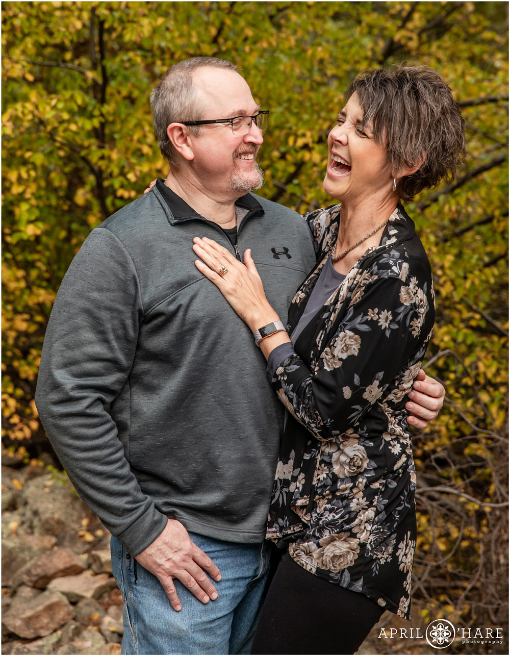 Adorable photo of a couple married for 25 years laughing together with a pretty fall color backdrop at Rocky Mountain National Park in Colorado