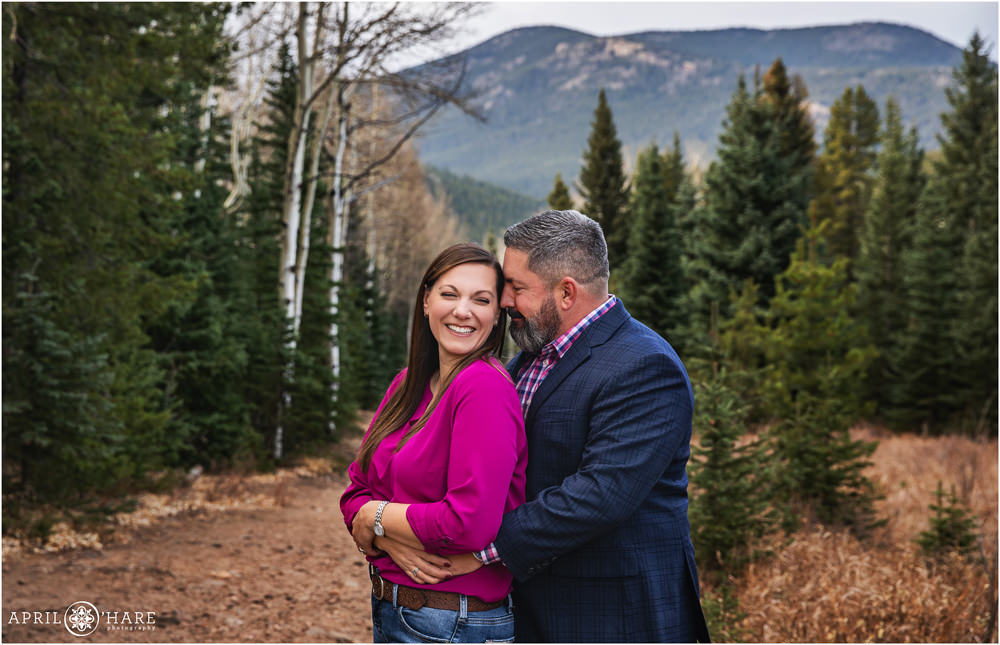 Cute photo of a couple at their family session with a pretty mountain backdrop in Evergreen