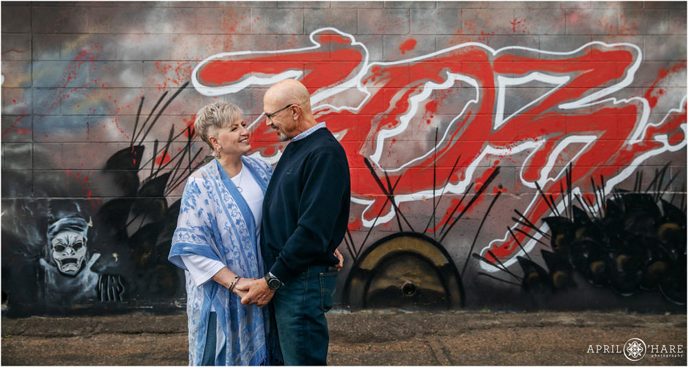 Cute couple in front of a 303 mural in Five Points of Denver Colorado