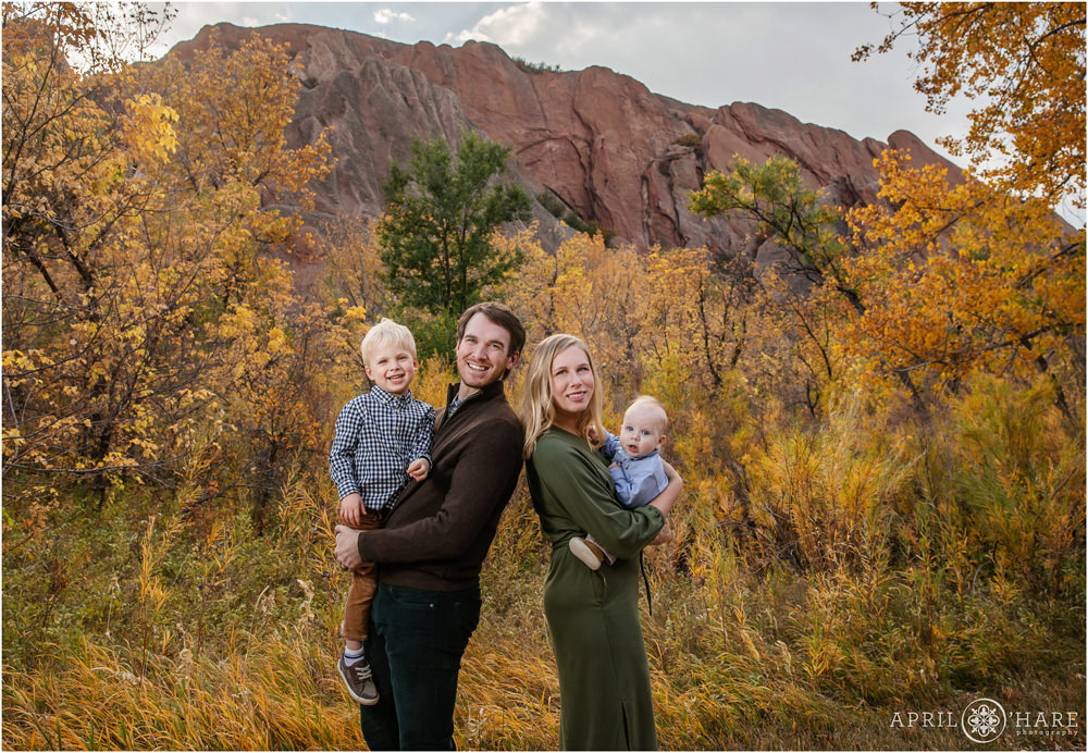 Cute family photo with dramatic red rock backdrop with fall color at Roxborough State Park