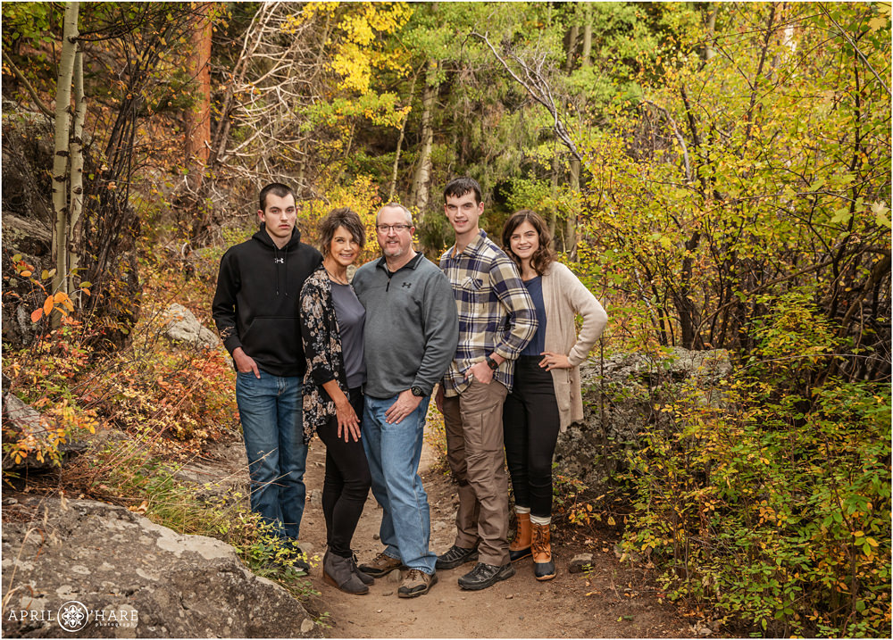 Gorgeous fall color family photo along the Fern Lake Trailhead at Rocky Mountain National Park