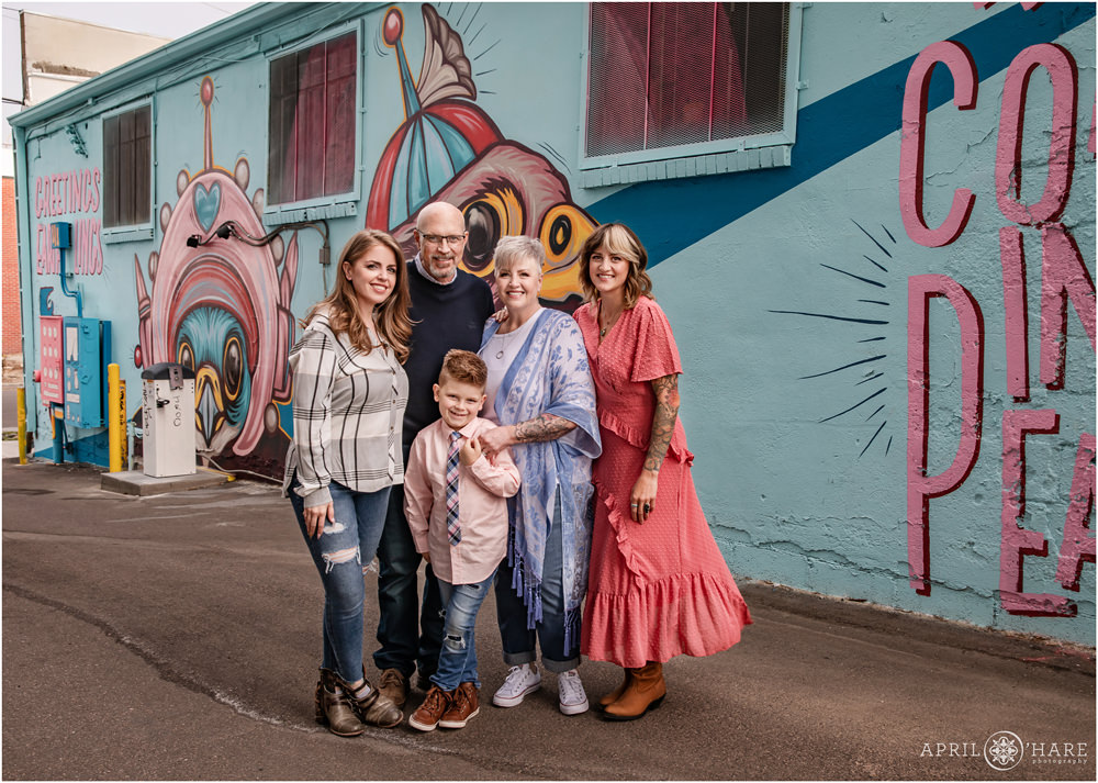Adorable family picture in front of Kaitlin Zeismer's pastel mural in Five Points Neighborhood of Denver Colorado
