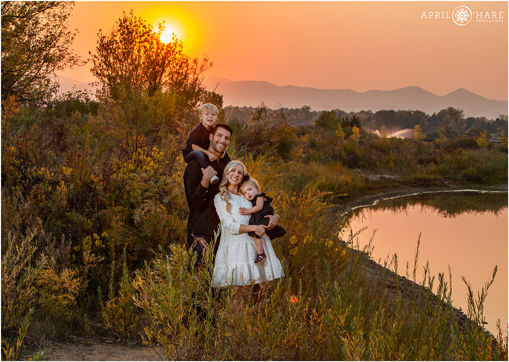 Red Sky Hazy Mountain View Family Portrait next to South Platte River in Littleton Colorado