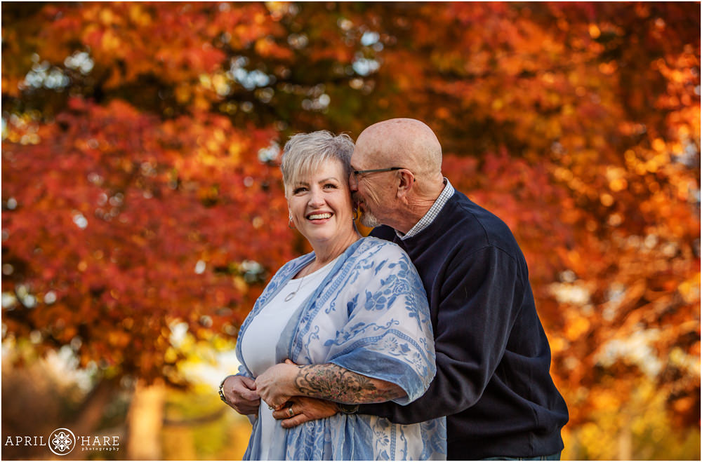 Candid couple portrait with a pretty fall color backdrop at City Park in Denver Colorado
