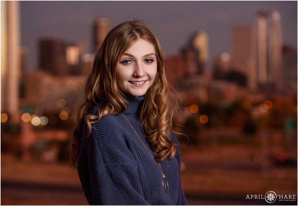Classic Headshot portrait for a high school senior girl with a Denver skyline sunset backdrop
