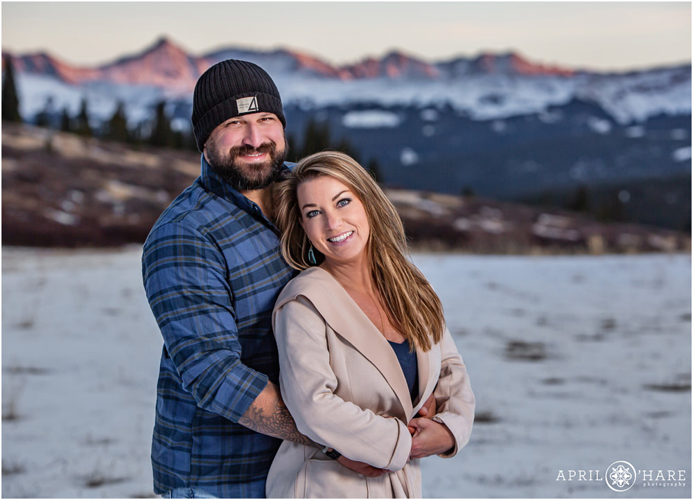 Couples portrait in front of Shrine Pass Mountain Views during Winter near Vail CO