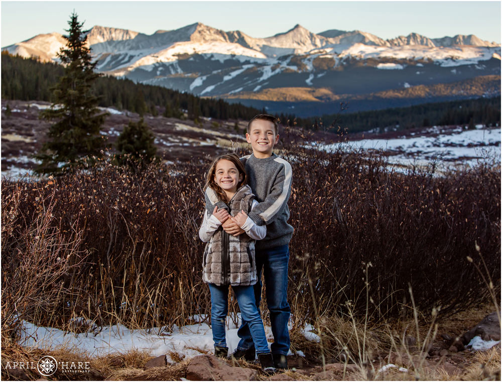 Brother and sister photo with Copper Mountain ski slope in the background at Shrine Pass near Vail