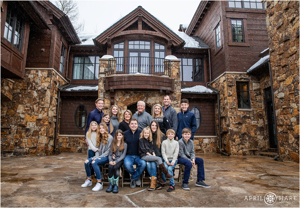 An Extended family of 16 people pose outside of their vacation home during ski season in Beaver Creek Colorado