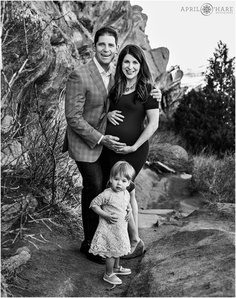 B&W Photo of an expecting couple with their young daughter on the Trading Post Trail at Red Rocks