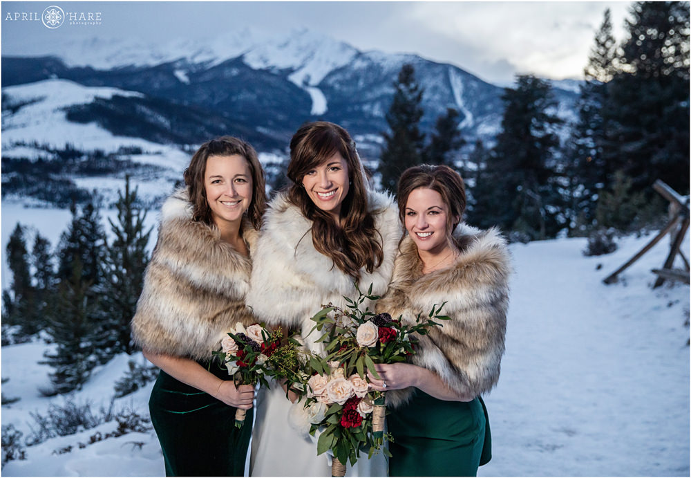 Bride and bridesmaids wearing green during winter at Sapphire Point in Colorado